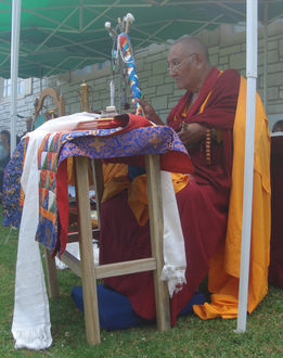 Khensur Jampa Tegchok Rinpoche waving the ritual arrow during the smoke offering ceremony to celebrate Tibetan New Year at Trashi Ganden Choepel Ling in Glenfield.
