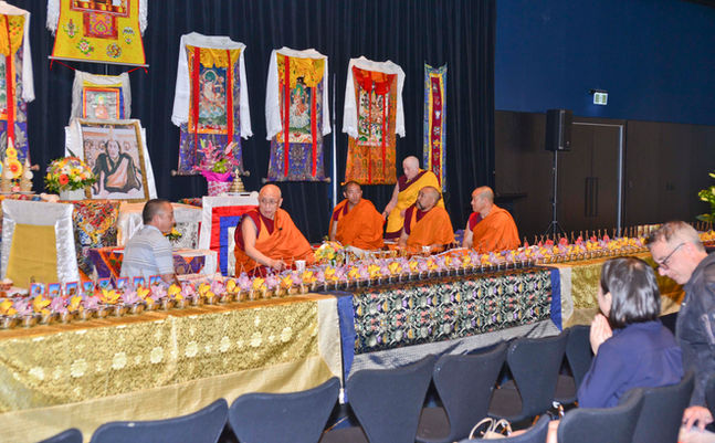 Geshe Sangyey Thinley of Jam Tse Dhargyey Ling giving a summary teaching on Lama Tsongkhapa's "Three Principal Aspects of the Path," assisted by interpreter Rinchen Dhondup at the Great Prayer Festival. Sangha listening in the background.