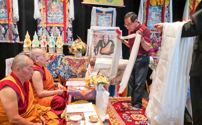 Sponsor making offerings to sangha at the Great Prayer Festival