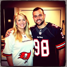 Smiling couple wearing Buccaneers jerseys