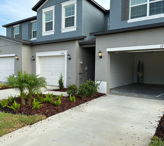 Two-story townhouses, landscaping, driveway