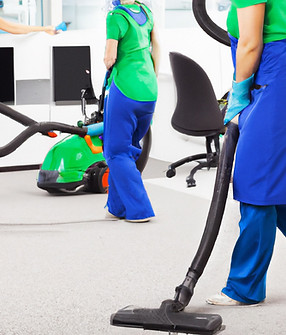 workers cleaning an office in blue and green with vacuum.jpg