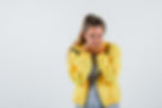 young-woman-holding-hands-mouth-t-shirt-jacket-looking-happy-front-view.jpg