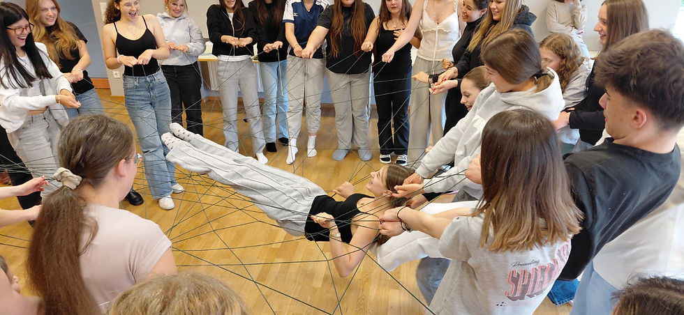 Schüler bilden beim Kennenlernnetz mit Schnüren ein gemeinsames Netz als Symbol für Klassengemeinschaft und Zusammenhalt