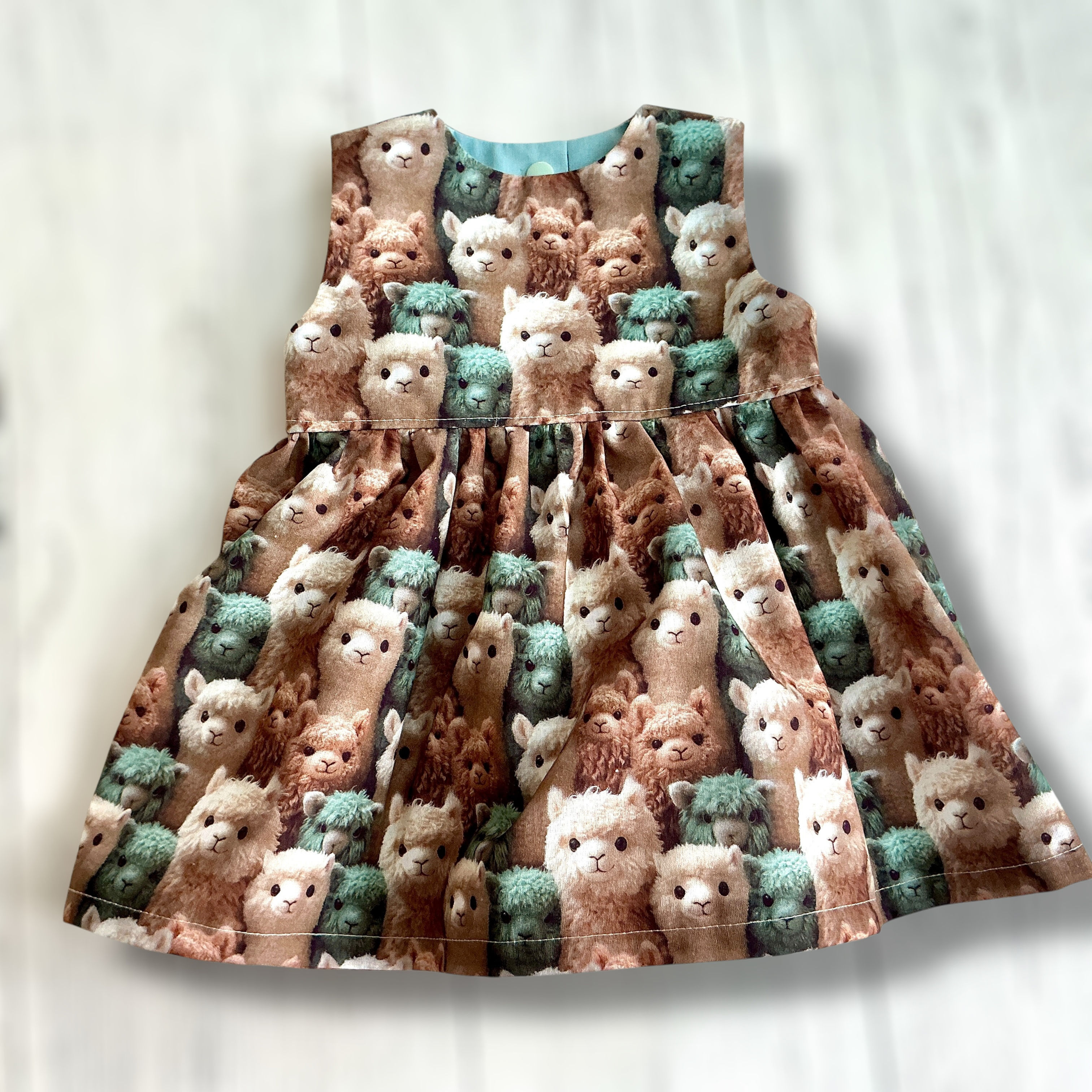 Girls Alpaca Faces 3d effect Print Dress front view on a light grey background
