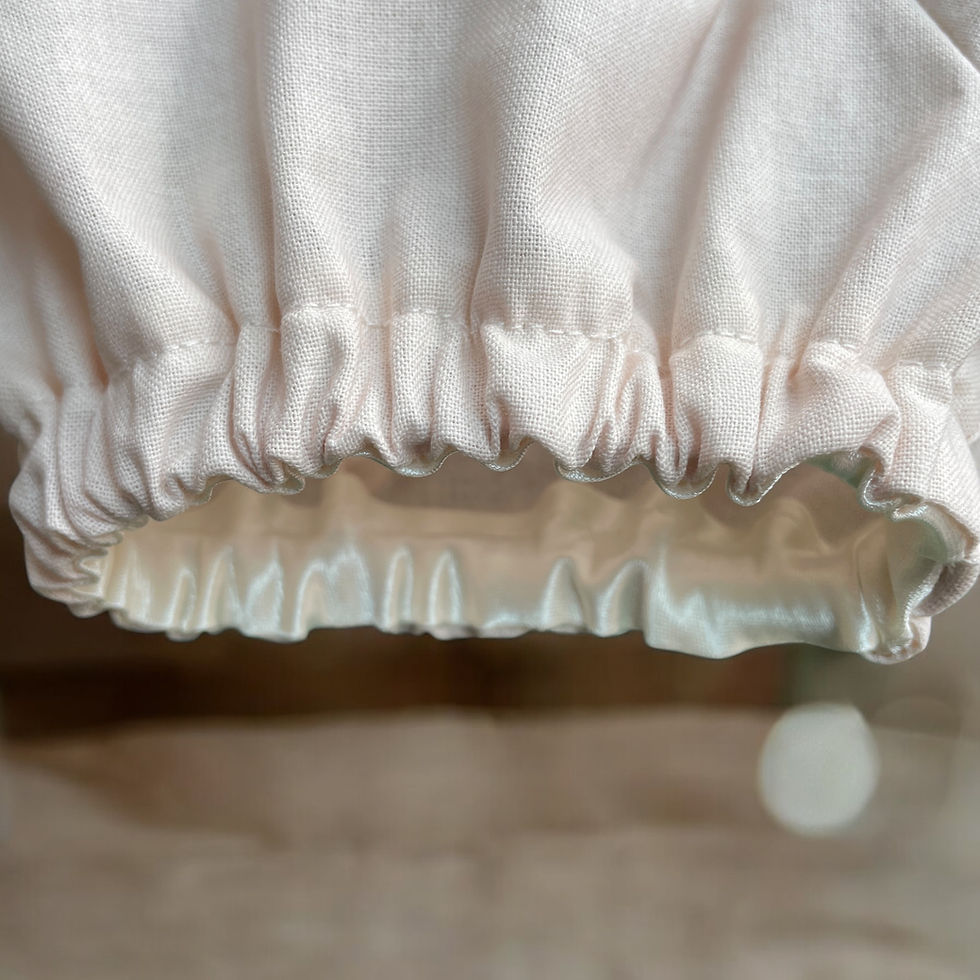 Thumbnail: Baby Girl Bloomers in a latte plain cotton fabric on a flat background showing elasticated leg band