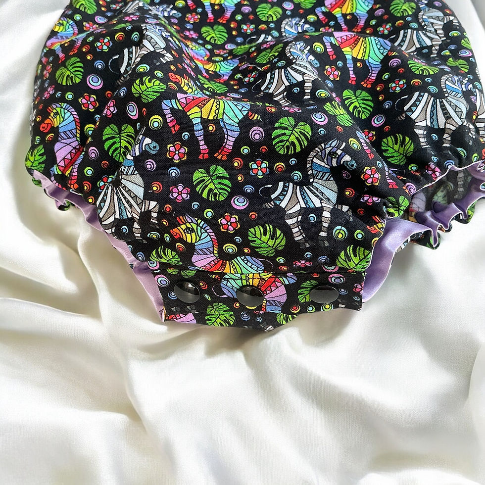 Thumbnail: Baby Romper with straps in a Vibrant Zebra and floral print in rainbow colours and black background