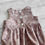 Thumbnail: Baby Bubble Romper Meadow print on light purple taupe cotton fabric, back bodice view showing snap fastening