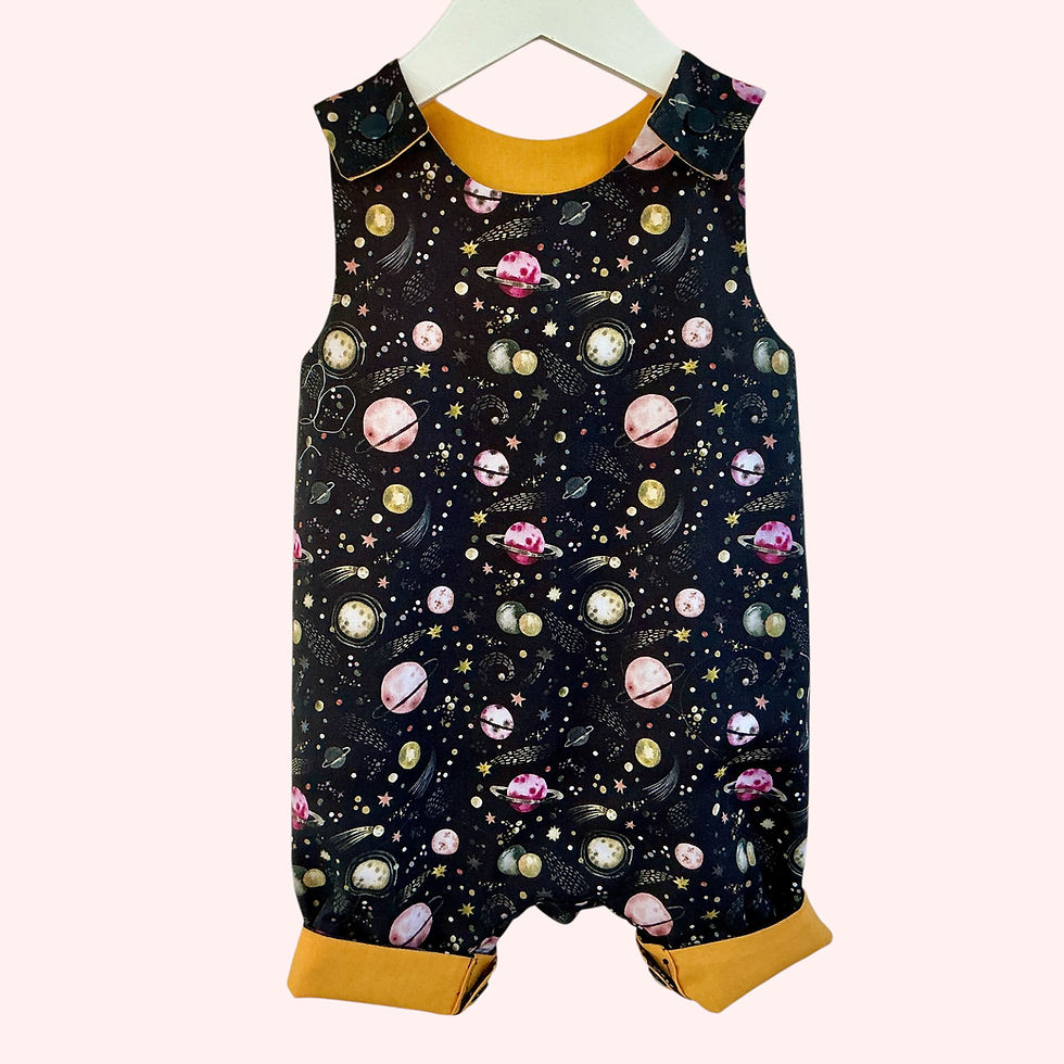 Thumbnail: Loose Fit Harem Style Dungarees with planet print hanging on a pale pastel background