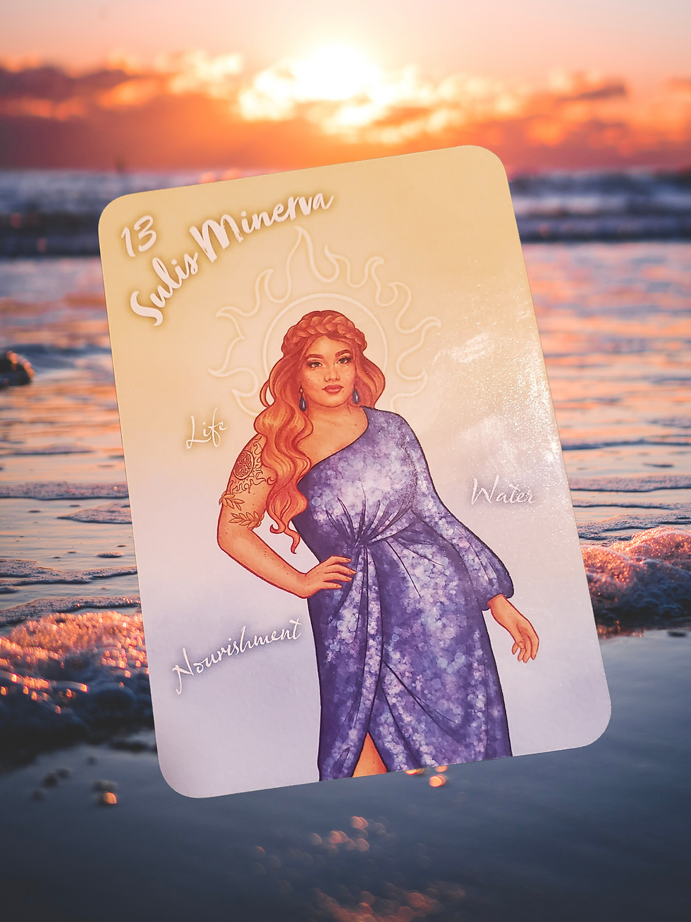 A card featuring “Sulis Minerva” with a woman in a purple dress against a sunset beach backdrop. Words include Life, Water, Nourishment.