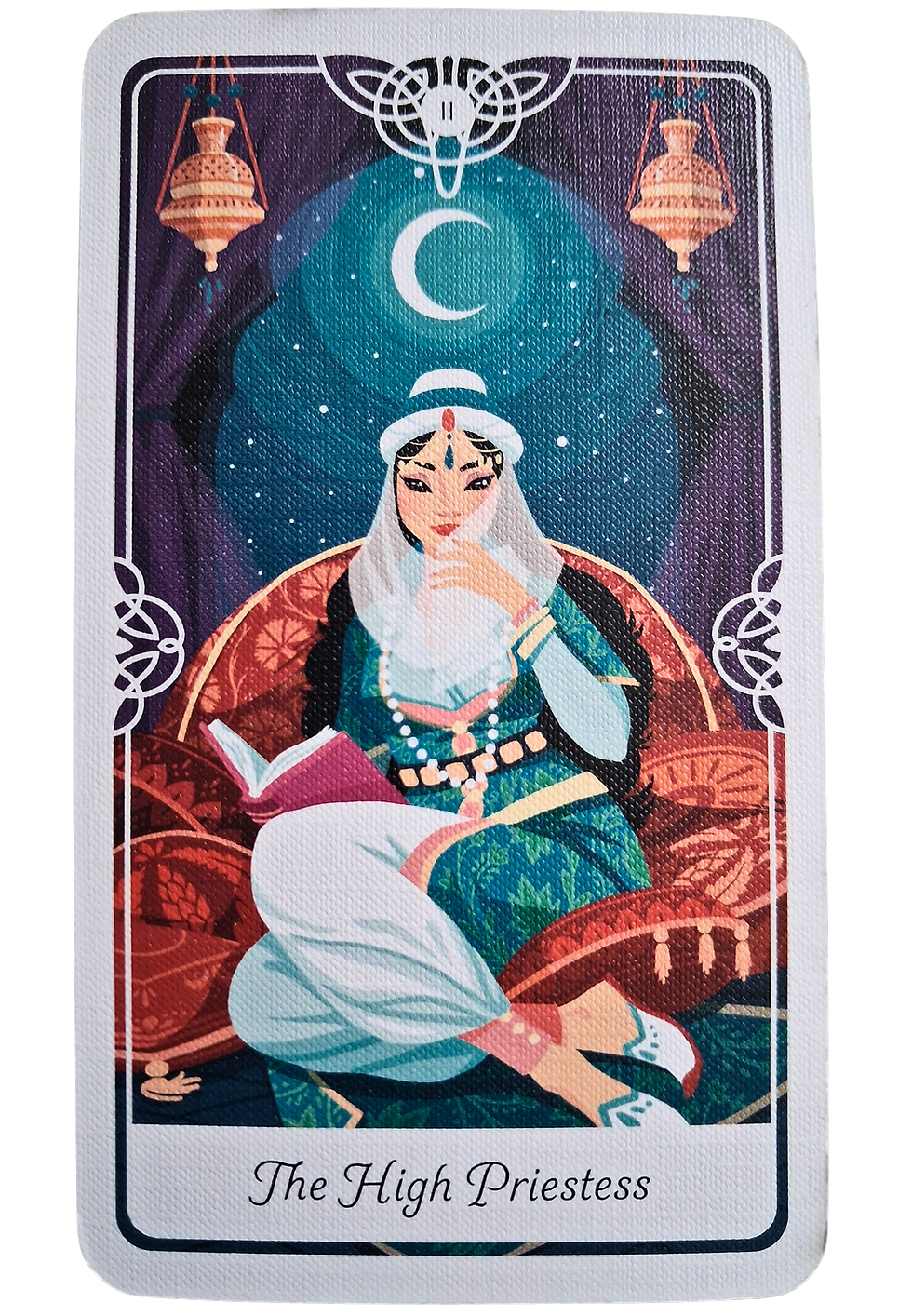 Tarot card of The High Priestess shows a serene woman in a blue robe, seated with a book. A crescent moon and stars adorn the background.