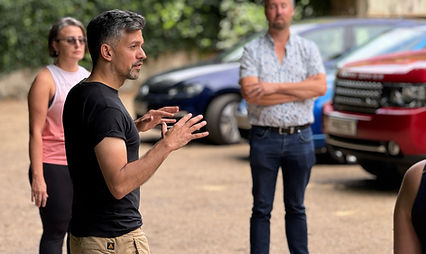 A man holding a talking standing up outside