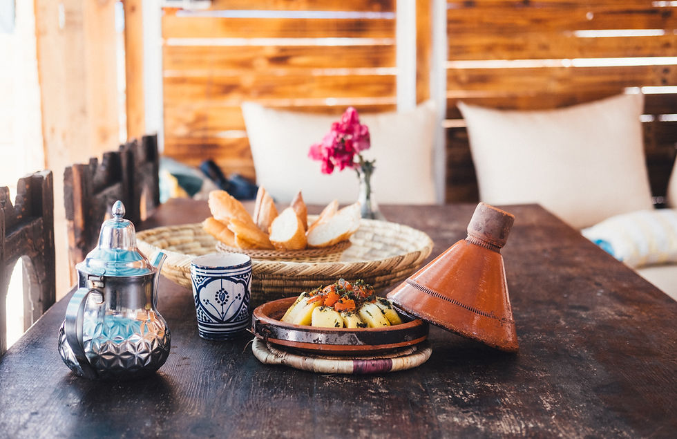 A Moroccan tajine rests next to a traditional pot of mint tea