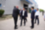 Magnus Lindahl shakes hand with one of his employees, with other employees surrounding them, during 20th anniversary in Kunshan, China.