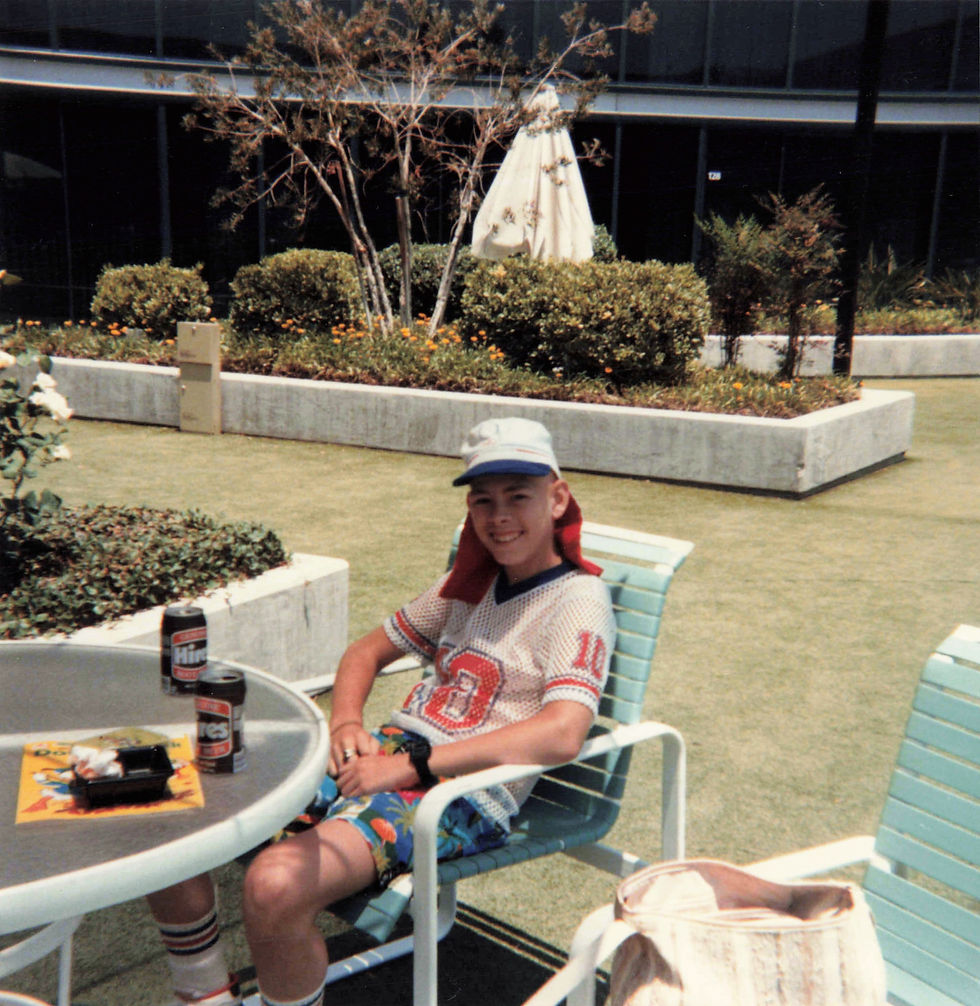 Clint slouching in a patio chair outside in the Anaheim Hilton courtyard.