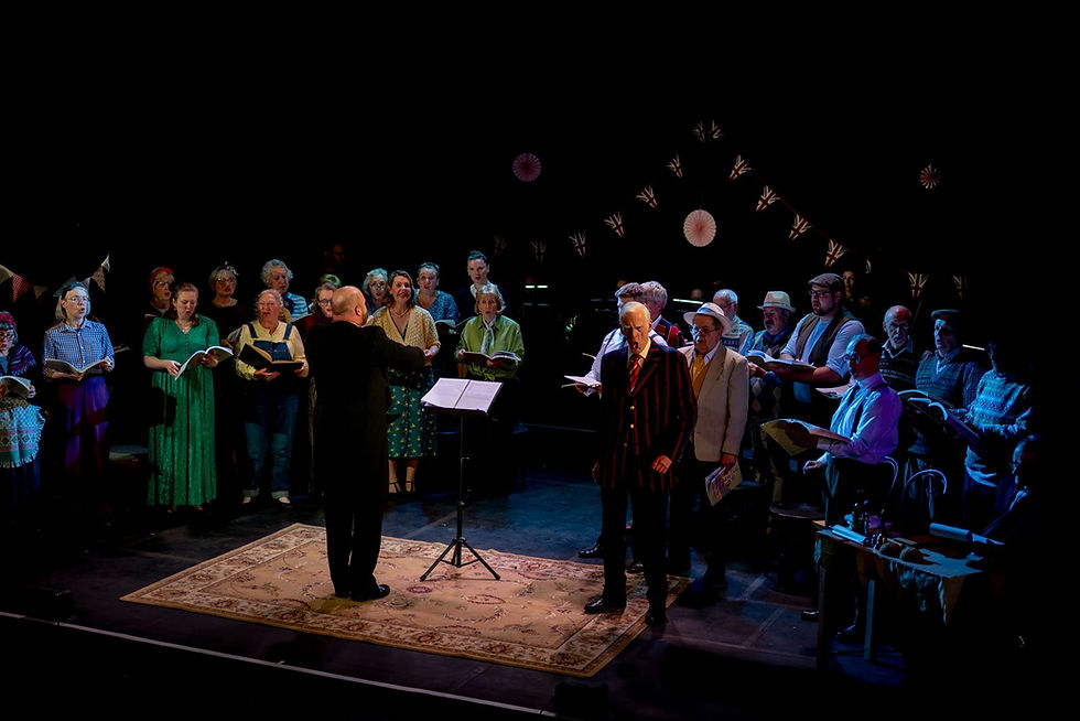 A conductor leads an adult choir performance with The Voice Hub in Cheltenham.