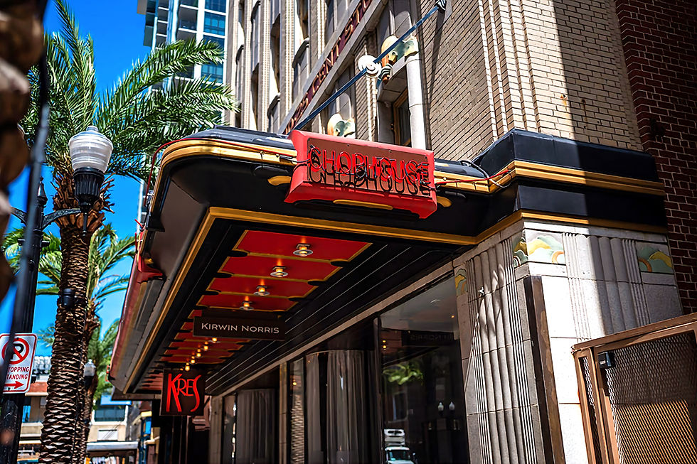 Brick building with "Chop House" neon sign and "Kres" below. Palm trees and a "No Stopping" sign in the sunny urban scene.