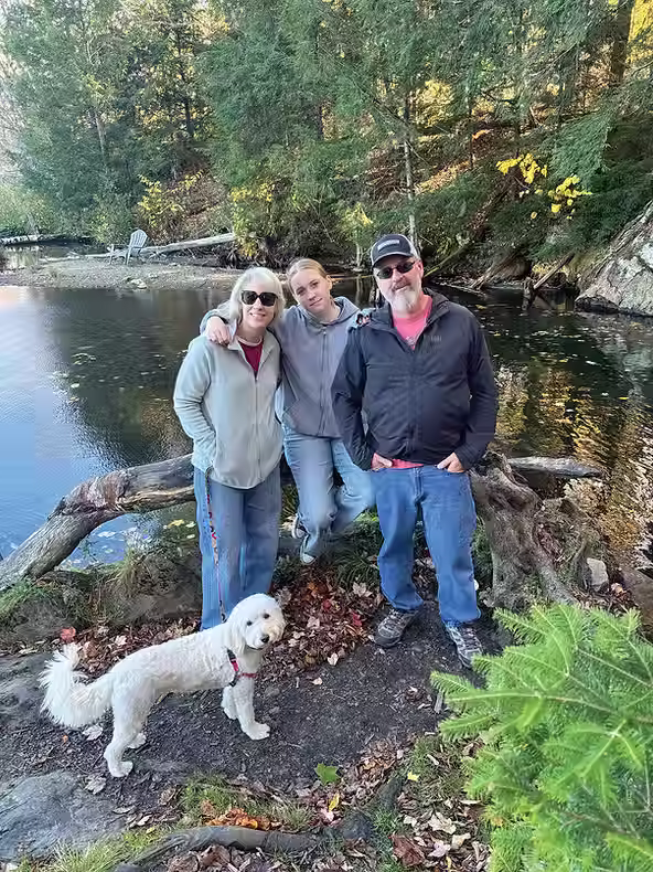The late Dan Negrelli, seen here with wife Karen, daughter Keira and dog Maple at Kent Pond in Killington, VT, made the most of his time in this realm.