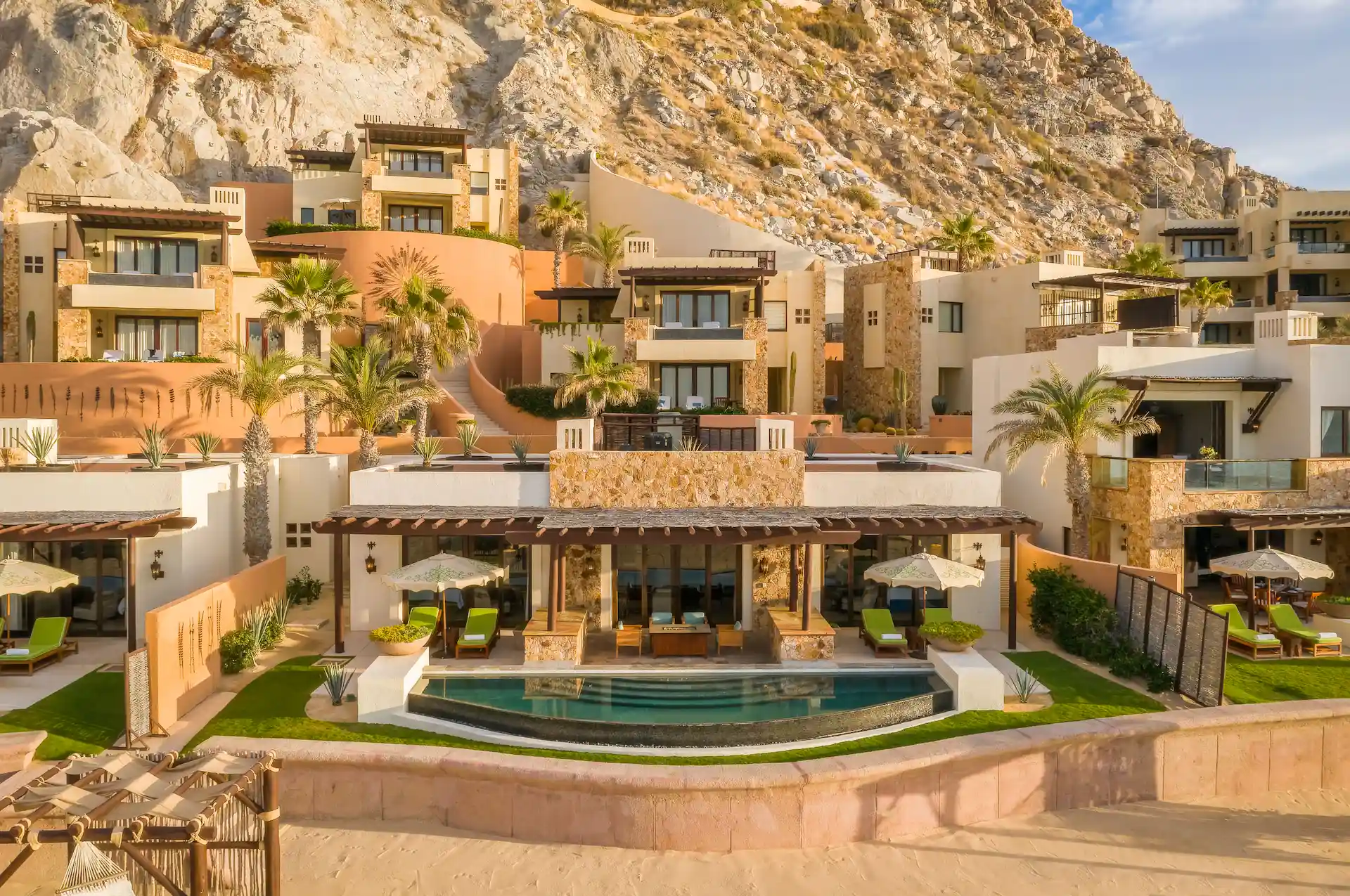 Aerial view of Waldorf Astoria Los Cabos Pedregal luxury resort villas and private pools carved into coastal cliffs