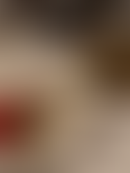 large triangular blocks of cheese and colorful tomatoes and peppers and fried eggplant circles on a table with a martini