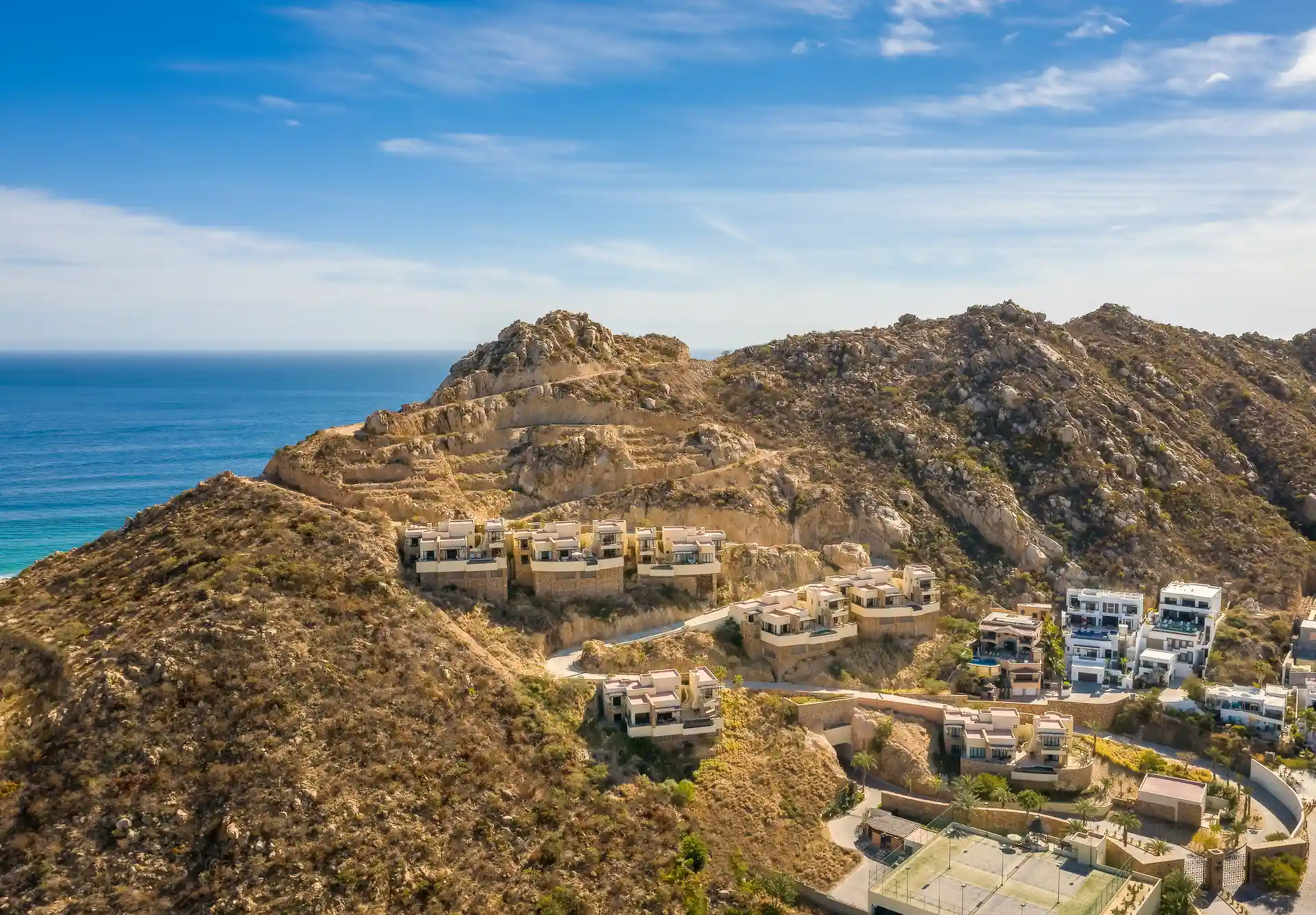 Aerial view looking at the multi bedroom villas perches on the cliffside of the Waldorf Astoria Los Cabos Pedregal resort