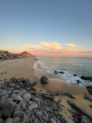 pastel colored sky over the rocks and white sand beaches at the Waldorf Astoria Los Cabos Pedregal