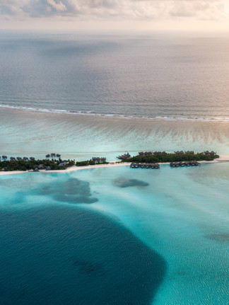 aerial view of the blue hues of water at the Conrad maldives