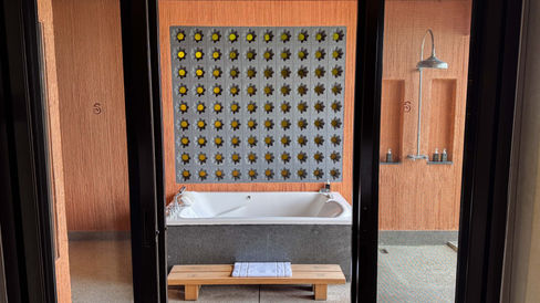 partially opened sliding door revealing an outdoor bathtub at Sri panwa resort 1 bedroom villa