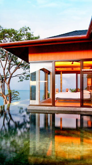 pool villa with large glass windows overlooking the ocean in Phuket