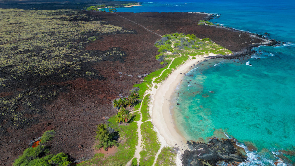 white sand beaches sandwiched between turquoise blue waters and black lava fields