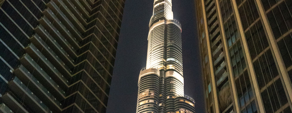 view looking up at the Burj khalifa at night illuminated at night