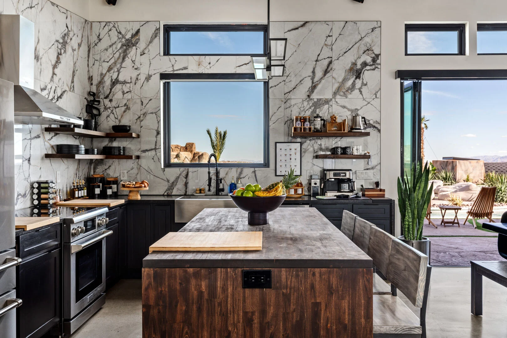marvel stone walls with large glass windows and modern stainless kitchen appliances 