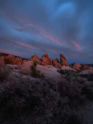 Twilight clouds over sculpted boulders near Arch Rock