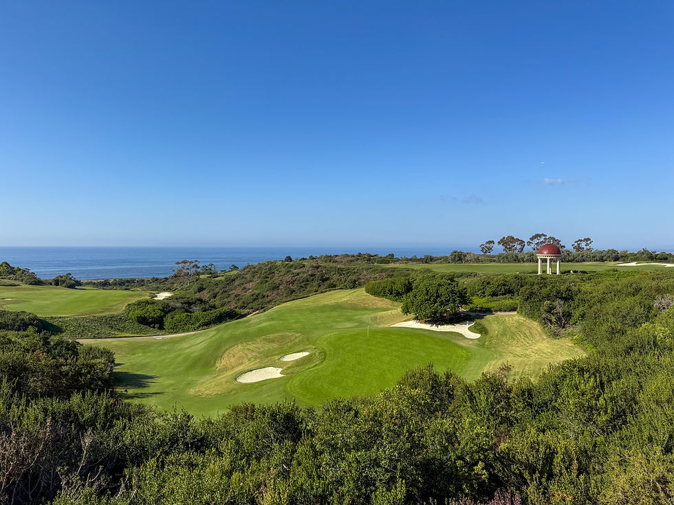 pergola perchec on top of grass oil with a golf course and ocean waters below