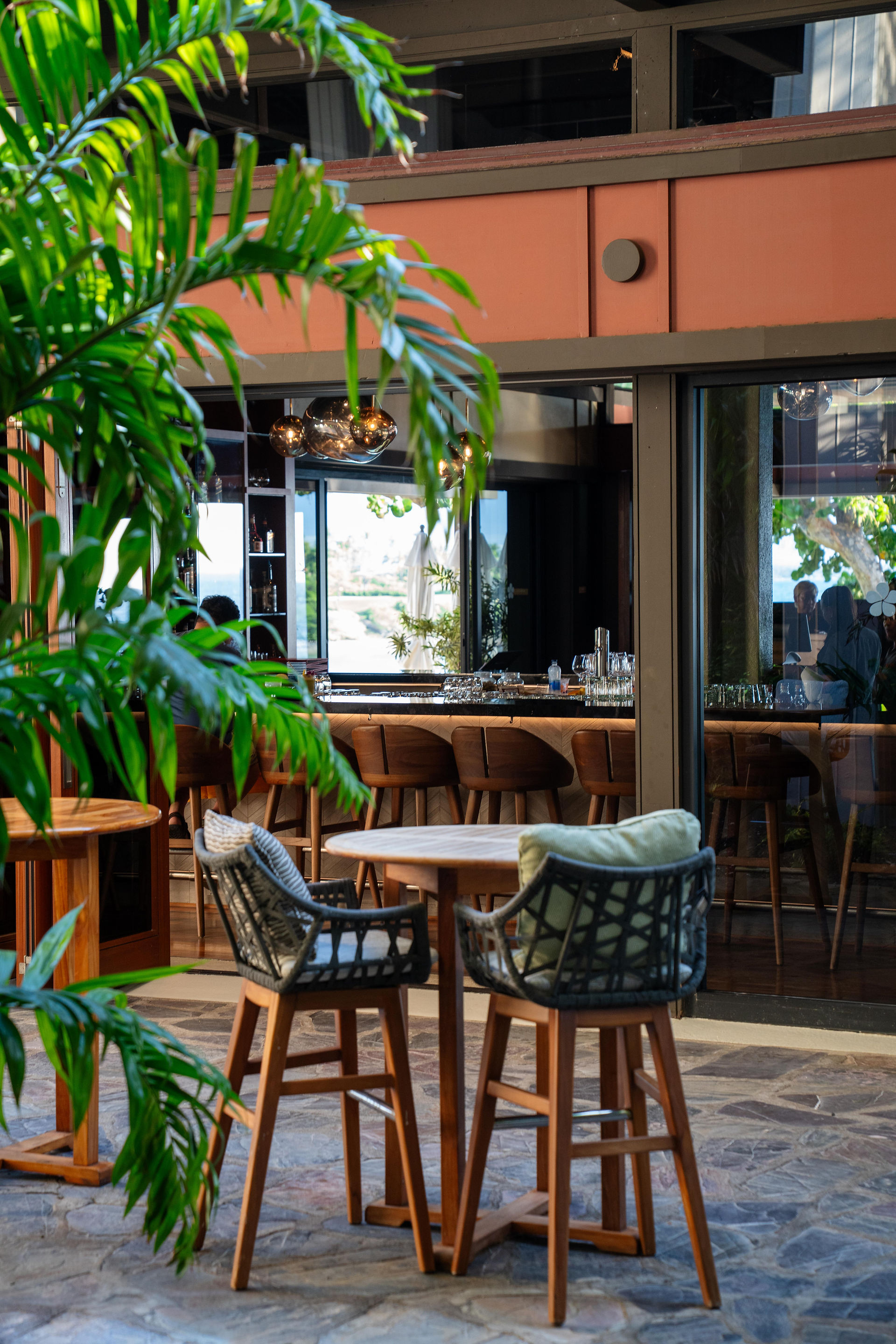cocktail bar tables surrounded by lush landscaping 