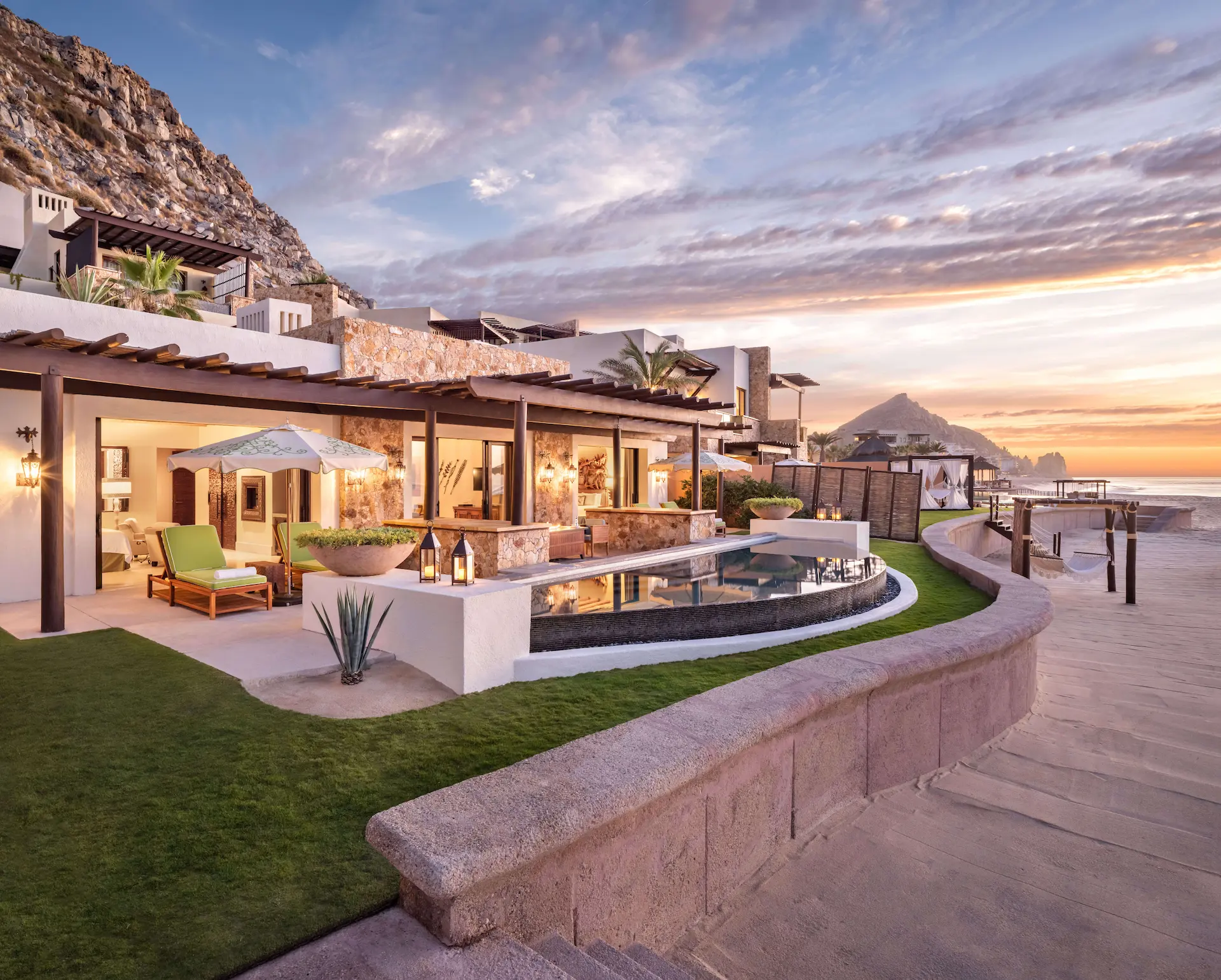 Ocean-view suite at Waldorf Astoria Los Cabos Pedregal with private plunge pool and terrace during a sunset colorful sky