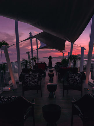 women silhouette overlooking the Cabo sunset from a roof top bar