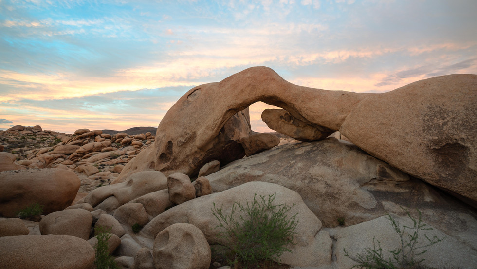 Golden hour across clusters of rounded Joshua Tree boulders