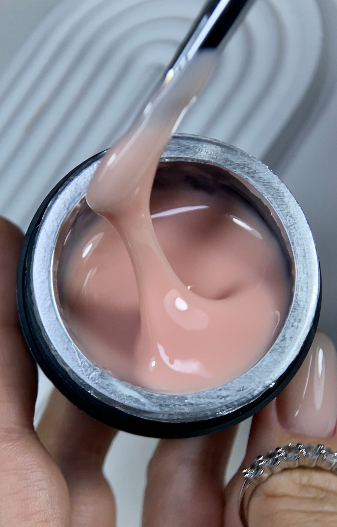 Light Beige Hard Gel being lifted with a nail brush.
