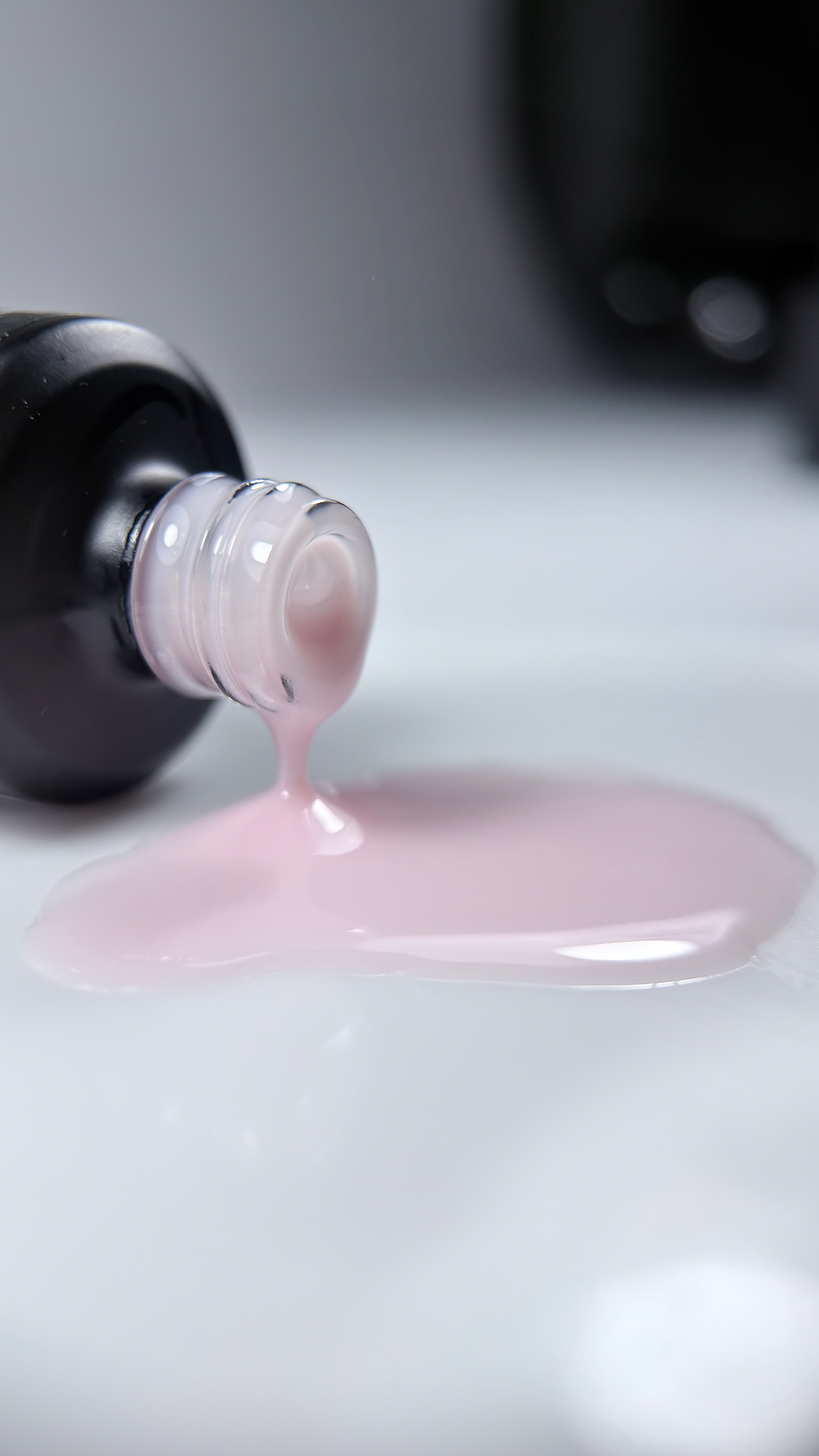 Almound Milk Liquid Gel pouring from a black bottle
