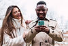joyful-multiethnic-couple-using-smartphone-in-park-2025-04-04-20-30-25-utc (2).jpg