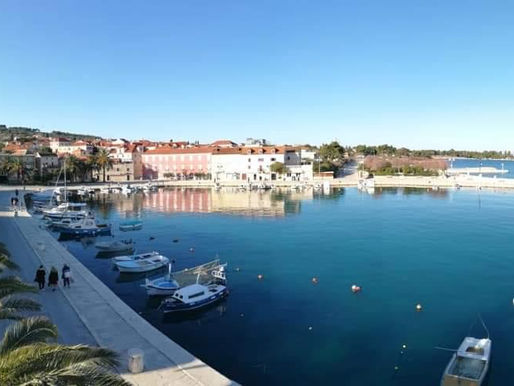 A tranquil view of Supetar's beautiful waterfront, showcasing the vibrant energy of Easter.