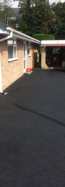 Tarmacadam Driveway leading to a garage