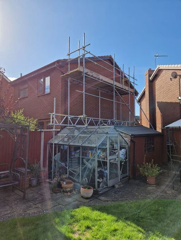 Scaffolding next to greenhouse