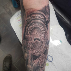 Tattoo of Newcastle Brown Ale Logo on mans leg