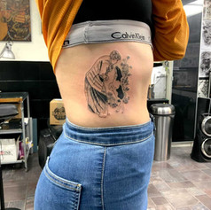 Woman speaking to her dog tattoo
