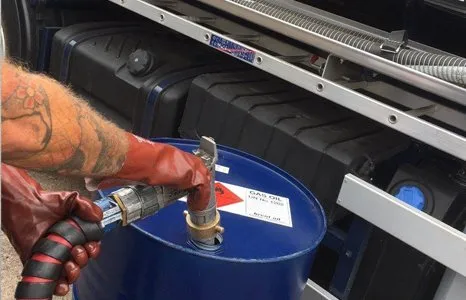 Man accessing Oil Drum