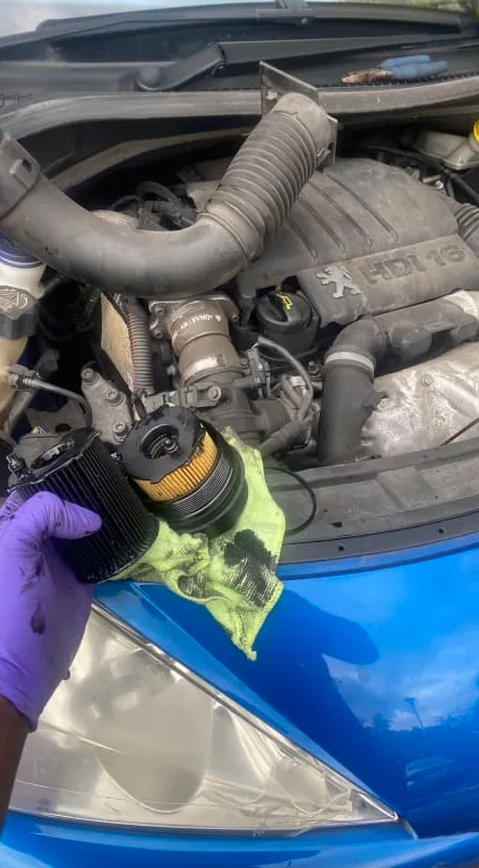 Man holding car component