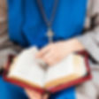 Priest reading from Bible