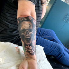 Skull Tattoo on mans right arm